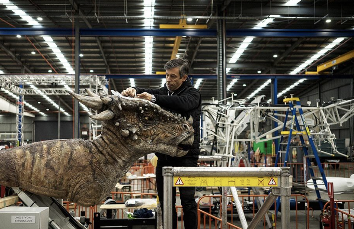 A Creature Technology employee at work on a lifelike animated dinosaur