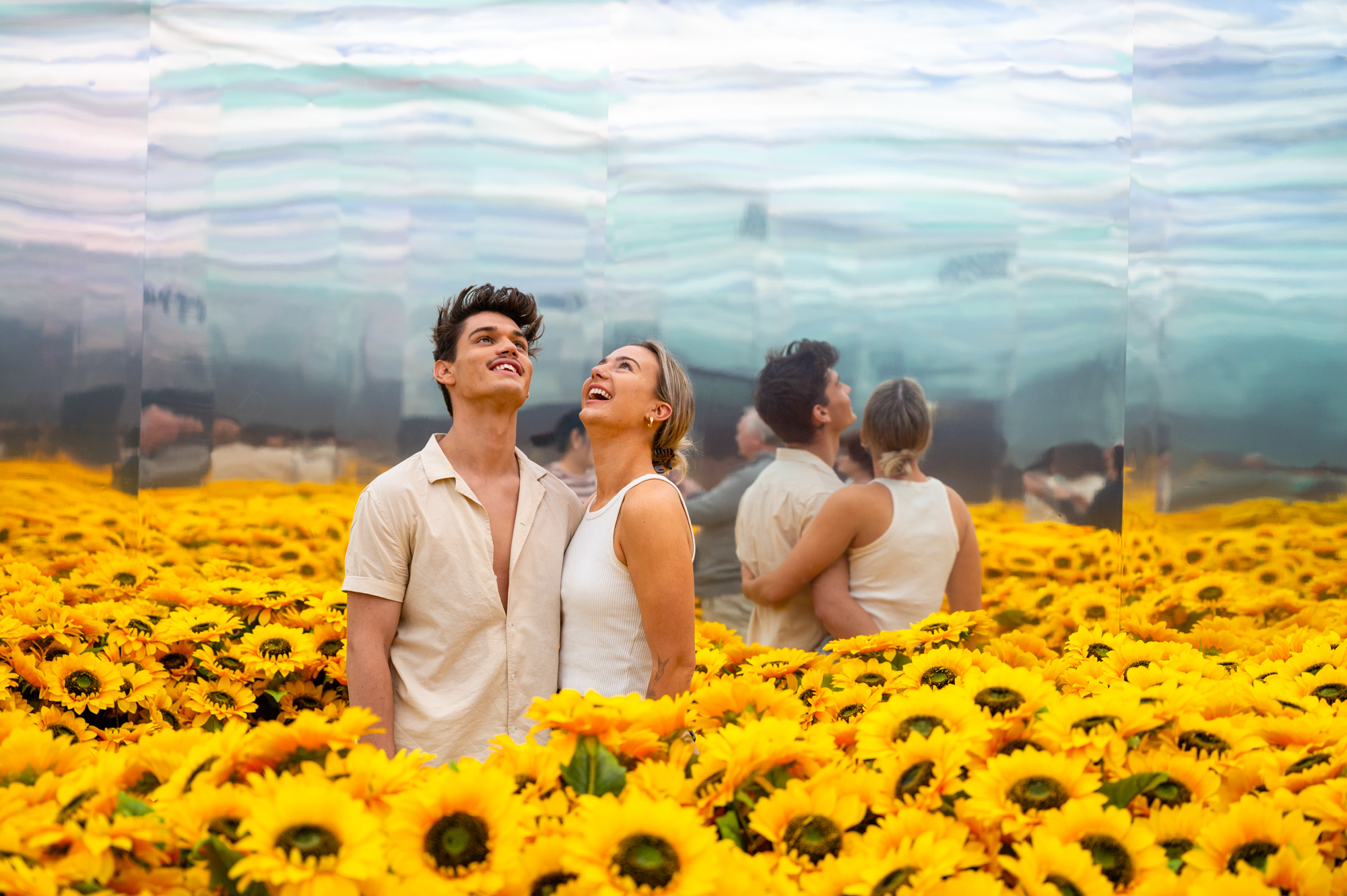 A young male and female in field of sunflowers at the Van Gogh Alive exhibition in Perth by Grande Experiences