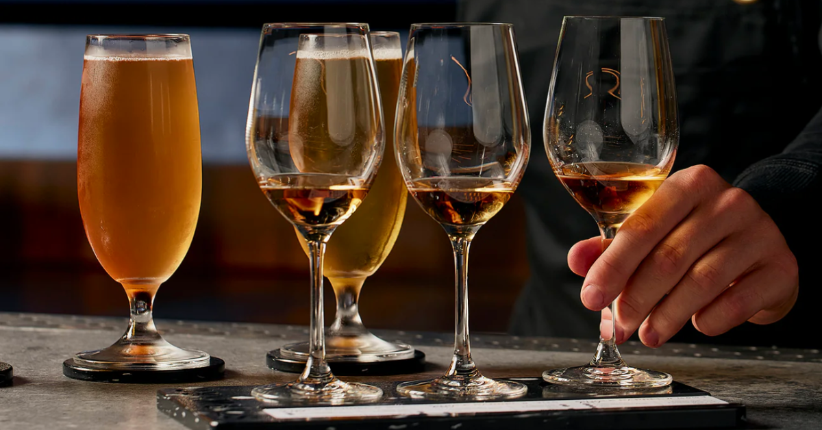 A bartender serving whisky and beer